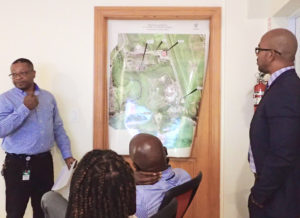 Adrian Taylor, interim executive director of the V.I. Waste Management Authority, points out locations of three recent fires at the Anguilla Land Fill. Also shown: Gwendolyn Kelly, Keith Richards, board chairman, and Nelson Petty, Jr., Public Works commissioner. (Source photo by Susan Ellis)