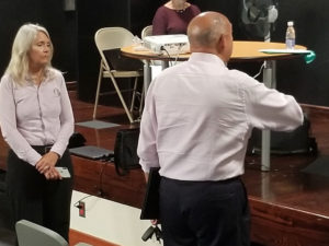 Amy Dempsey of Bioimpact stands to the left of lawyer George Dudley, representing Coral World, as he testifies before the Coastal Zone Management Commission on Sep. 11. (Source photo by Bethaney Lee)