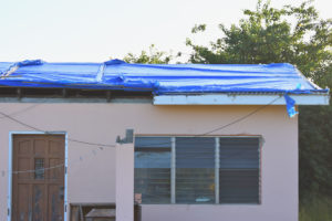 Lawrence Harley's home still lacks a roof despite the mountain of paperwork he's delivered to various agencies. (Source photo by Wyndi Ambrose)