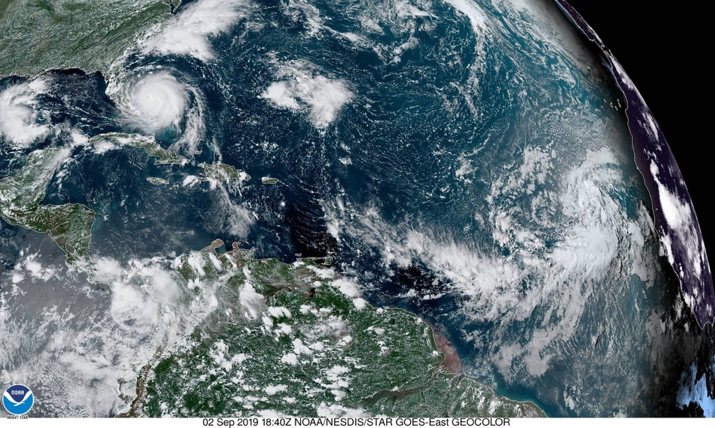 Satellite photo shows, from left, a low-pressure system moving west across the Gulf of Mexico, Hurricane Dorian smashing across the Bahamas and bearing down on the U.S. coast, and to the far right, a tropical wave with a 90 percent chance of forming a tropical depression by week's end. (NOAA photo)