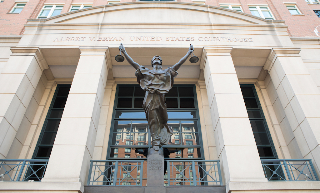 A statue of "Blind Justice" graces the entrance to the Albert V Bryan U.S. Courthouse in Alexandria, Virginia, where Scott MacKenzie pled guilty to election law violations. (Shutterstock image)