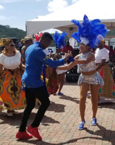 Enchanted Entertainment CEO Camelia Frebes pulls an audience member from the crowd to dance during the entertainment at Saturday's celebration. (Photo Bethaney Lee)