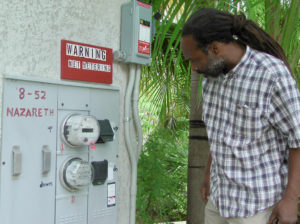 Energy Office technician Carl Joseph inspects a net metering site in 2010 on St. Thomas in the territory's previous program. (Source file photo by Don Buchanan)