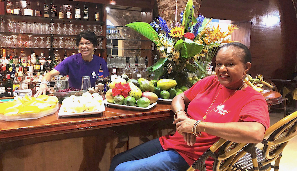 Pauline Alexander, left, and proprietor Gladys Isles-Jones welcome customers to Gladys’ Cafe in the restaurant's new Royal Dane Mall location. (Source photos by Teddi Davis)