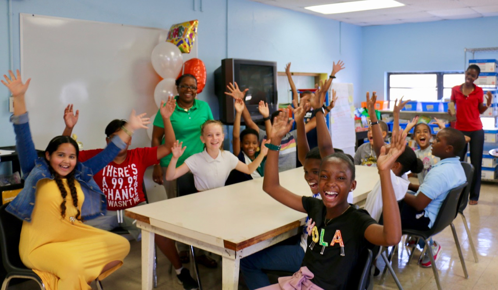 Zarah O’Reilly Bates stands in front of colorful balloons as her students wave and smile celebrating her award as St. Croix Teacher of the Year 2020. (Source photo by Linda Morland)