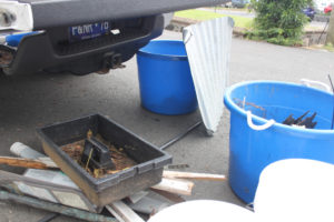 Volunteers find large construction materials and automotive parts that are plucked from the grounds near Fort Christian, weighed and then hauled off. (Source photo by Bethaney Lee)