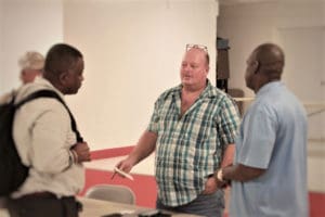 Julian Magras, center, speaks with Sens. Athneil Thomas, left, and Stedmann Hodge. (Source photo by Bethaney Lee)