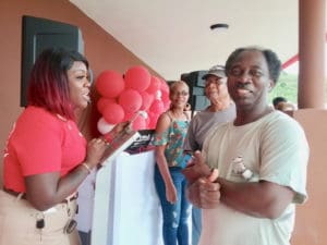 CostULess employee Tamika Woodley helps returning customer Jean Paul sign up for a newly issued discount card on Friday. The popular warehouse grocery store reopened after damages from Hurricane Irma closed it in September 2017. (Source photo by Judi Shimel)
