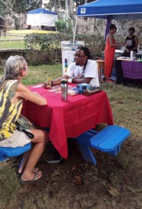 Akeem McIntosh gives a tarot reading. (Source Photo by Darshania Domingo)