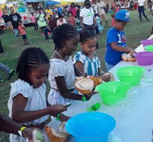 Children take part in the scooping contest. (Source photo by Darshania Domingo)