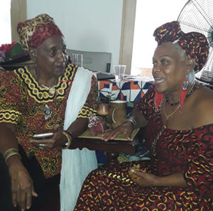Iya Tahira, left, and Makeda Kamara, share in the Kwanzaa festivities. (Source photo by Darshania Domingo)