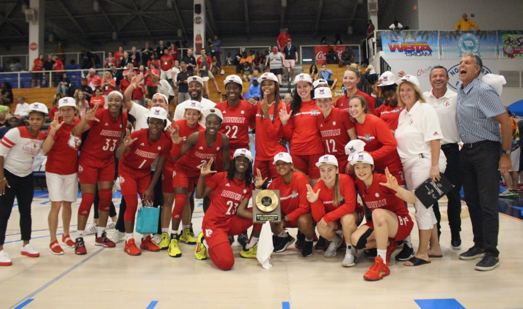 The Louisville Cardinals celebrate Saturday after capturing the Island Division in the 20th annual Paradise Jam. (Photo by Basketball Travelers)
