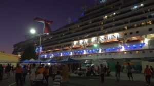 2- The Carnival Sunshine stayed in port for the event, illuminating the stage set up near the dock. (Source photo by James Gardner)