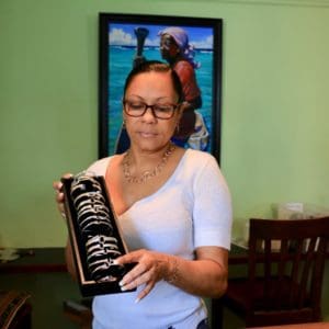 Lydia Palin, the retail store manager, holds an array of the signature St. Croix Hook bracelets ready for customers. (Source photo by Linda Morland)