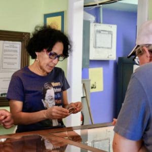 Nellie O’Reilly, one of the new owners of Sonya’s Ltd., helps a customer choose a bracelet. (Source photo by Linda Morland)