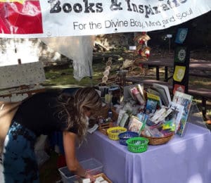 A customer looks through the wares at the Love and Light Booth. (Source Photo by Darshania Domingo)