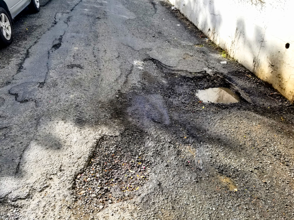 This damaged road on St. Thomas's south side is riddled with potholes. (Source photo by Bethaney Lee)