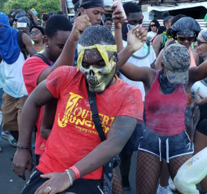 The J'ouvert Junction troupe dances down the route. (Source photo Melody Rames)