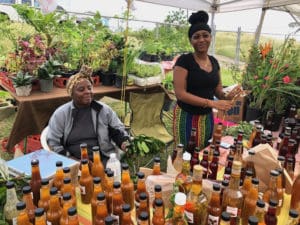 Jeanne Fatie Delsoin and Britany Leonard sell sauces and liquors produced from fruits and vegetables grown in Bordeaux. (Source photo by Gal Karlsson)