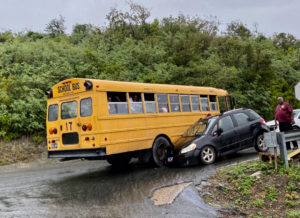 A school bus and a private vehicle are locked together after an accident on Cassie Hill. (Photo supplied by a Source reader)