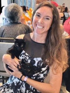 The Humane Society’s shelter manager Brianna Berks cuddles a kitten during the Valentine’s fundraiser. (Photo submitted by Annette Zachman)