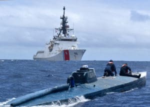 In a separate, similar incident at sea, U.S. Coast Guard Cutter Munro crew members inspect a self-propelled semi-submersible June 19, 2019, in international waters off Ecuador. The vessel was carrying more than 39,000 pounds of cocaine. Crew membes of a similar submersible were interdicted by the Cutters Hamilton and Resolution a month earlier and pleaded guilty in District Court on St. Thomas. (U.S. Coast Guard photo)