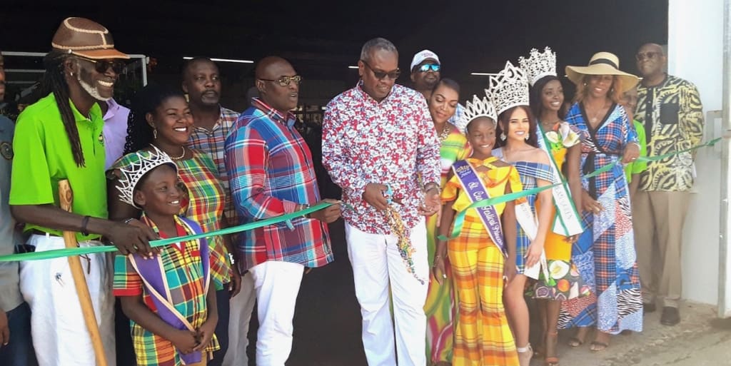 Gov. Albert Bryan Jr., joined by other dignitaries, cuts the ribbon opening the exhibition hall. (Source photo Darshania Domingo)