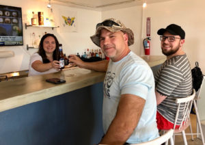 Bartender Joanne Adams serves up ice cold beer to cruise ship passengers Mark Lotthammer and John Cox of Sarasota, Florida at The Pelican Shop. (Source photos by Teddi Davis)