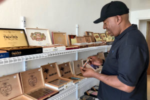 Al Williams of Colorado Springs peruses a selection of cigars on display at The Pelican Shop on the waterfront in downtown Charlotte Amalie. (Source photos by Teddi Davis)