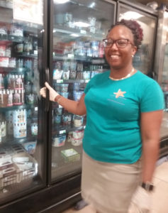 Starfish Supermarket Manager Nedra Ephraim checks the store's supply of ice cream, a popular item as coronavirus comes to V.I. (Source photo by Judi Shimel)