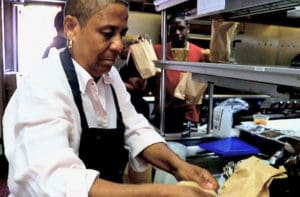 Chef Lenyse Shomo works with the team from Navy Beach to cook and bag almost 100 soups for delivery to residents at the Celestino A. White Senior Citizens Complex on St. Thomas. (Source photo by James Gardner)