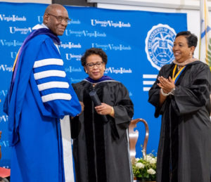 UVI president David Hall congratulates AG Loretta Lynch on reciept of her honorary degree as vice chair Oron Roebuck, right, looks on. (Source photo by Elisa McKay)