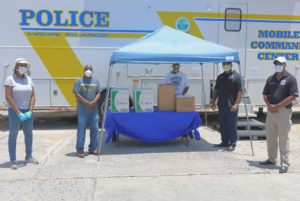 From left, Delegate Stacey Plaskett, Police Commissioner Trevor Velinor, Police Corporal Uston Cornelius, St. Croix Chief of Police Sidney Elskoe, and S\special assistant to the Chief of Police Lieutenant Walton Jack, Jr. stand in front of the VIPD’s Mobile Command Unit with the food donated by actress Naturi Naughton. (Image courtesy of Delegate Stacey Plaskett's office)
