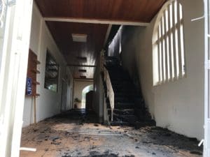 The interior of the church's vestibule shows the damage from smoke and flame. (Source photo by Elisa McKay)