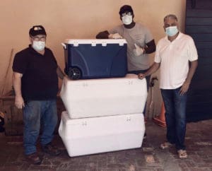 Scott Bradley, Julius Jackson, and Pash Daswani are ready to transport meals purchased by Daswani from MBW for the emergency room staff at the Snider Regional Medical Center. (Photo provided by My Brothers Workshop)