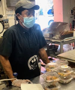 Rasheed Baker helps set up lunches for distribution at My Brothers Workshop and Cafe. (Photo provided by My Brothers Workshop)