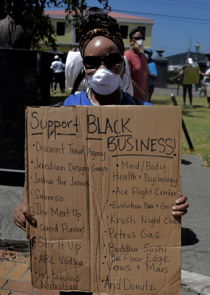 One protester showcases black-owned busisnesses on St. Thomas. (Source photo by Kyle Murphy)