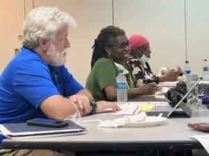 JFL board members, from left, Christopher Finch, Dr. Anne Treasure and Faye John-Baptiste discuss the hospital rebuild.