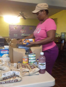 Myrtle Nicholas packs food at the Cruz Bay Seventh-day Adventist Church. Photo provided by Annette Small.
