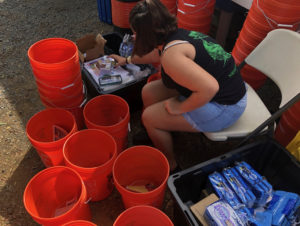 Storm Strong Program Graduate Amber LaPlace assembles hurricane preparedness kits to distribute to community members at the 2019 St. Thomas and St. John Agriculture Fair. (Photo by Kristin Wilson Grimes)