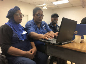 Storm Strong Program Participants Denise Webster and Marguerite ‘Sister’ Price, and project team member Jarvon Stout work on their community cookbook project idea at a workshop session in June 2019. (Photo by Allie Durdall)