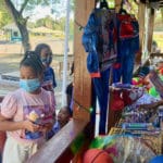 Photo 3 – Children wearing masks received free toys on Sunday during a toy drive at the Lareine Chicken Shack (Photo by Diana Dias)