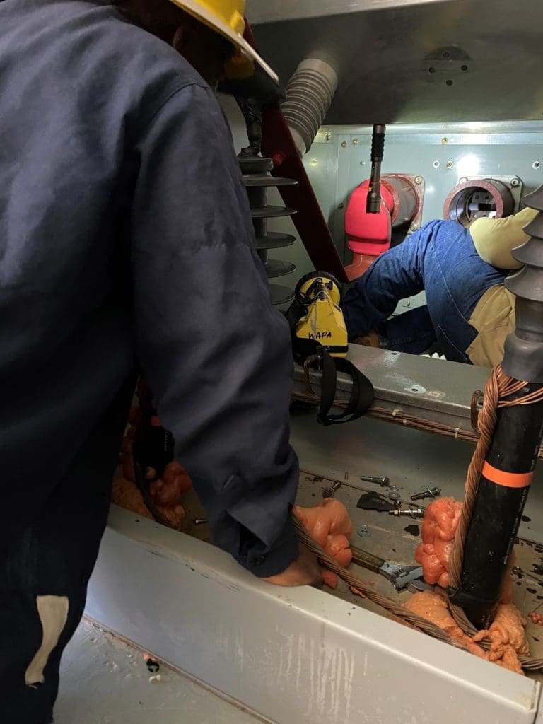 WAPA personnel make repairs to an equipment cubicle at the Donald Francois electrical substation in Long Bay, St. Thomas. (Photo by V.I. Water and Power Authority)