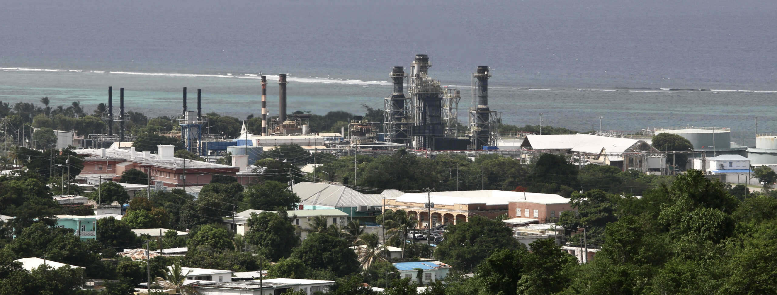 The WAPA facility in Christiansted, St. Croix, towers over surrounding buildings as it lets off steam. (Source photo by Linda Morland)