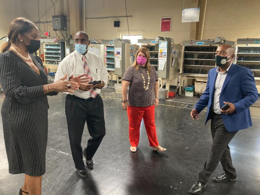 From left, Stacey Plaskett, David Stevens, Jennifer Gonzales-Colon, and Cletis Clendinen discuss the latest issues surrounding mail distribution in the territory. (Source photo by Adisha Penn)