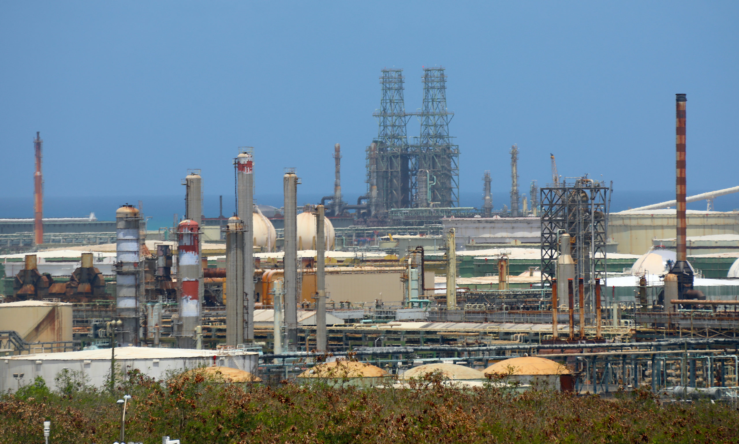 The twin towers of Limetree Bay refinery's coker rise in the distance on Tuesday, May 25, on the south shore of St. Croix, USVI. A coker malfunction contributed to the refinery's shutdown and bankruptcy. (Source photo by Patricia Borns)