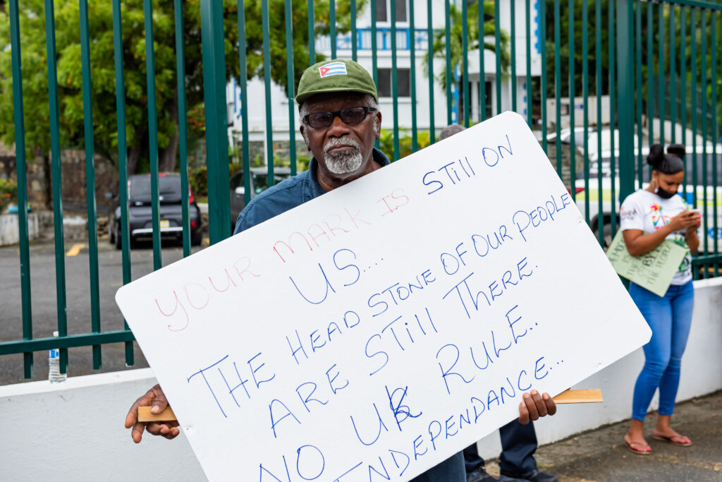 A man's sign says it all during a protest Monday against Britain's proposal that it directly rule the British Virgin Islands in light of a commission of inquiry that alleges widespread government corruption. (Photo by Cleave)