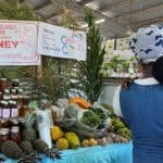 Honey Man, far right, speaks with patron about locally harvested honey in St. Croix at the 50th AgriFest.
