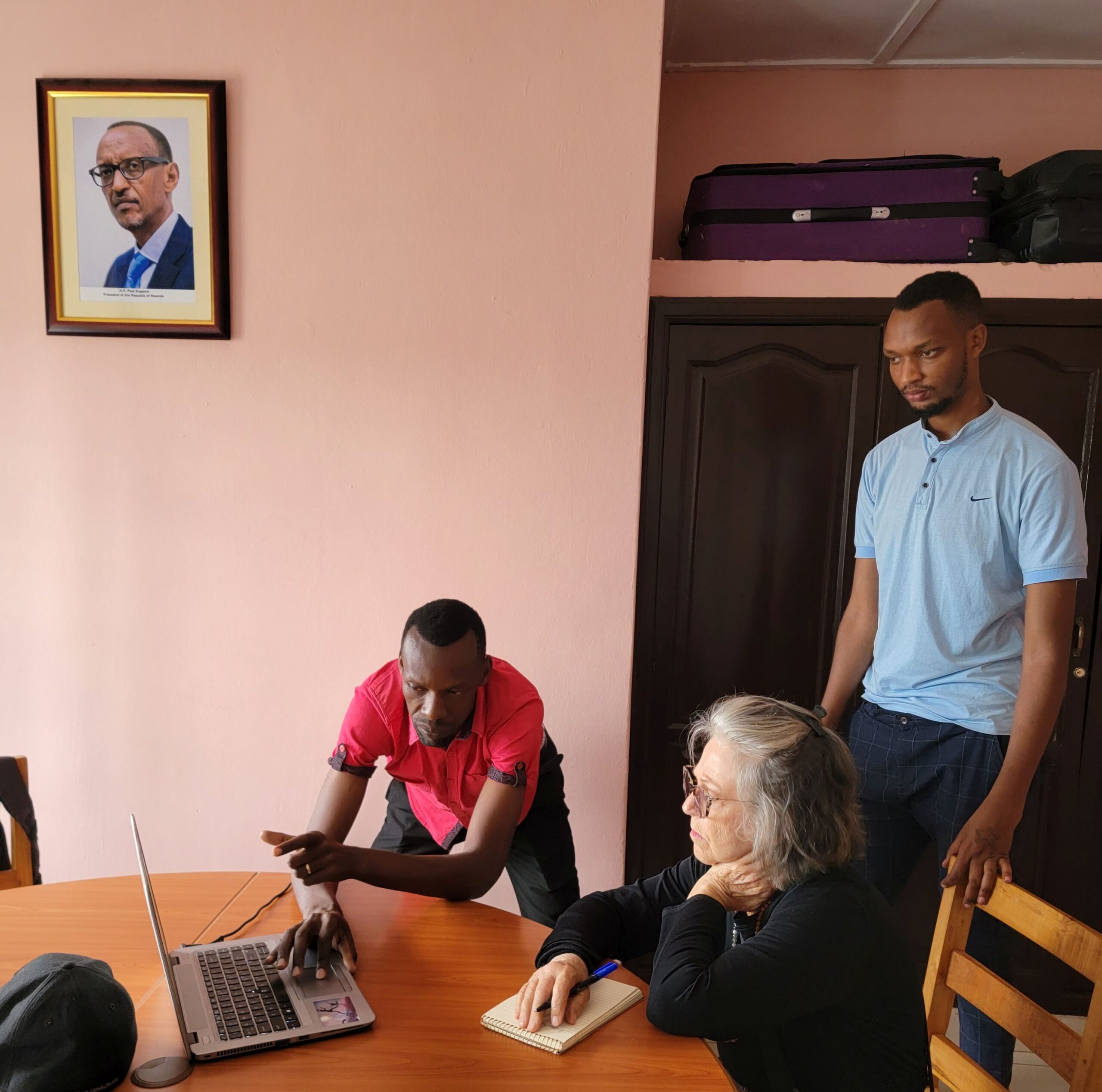 Bashir Karenzi, MindLeaps, Africa program director, and Vedaste Nyambe, the Rwanda country director, demonstrate to Shaun Pennington how they use data to track the progress of MindLeaps participants. (Submitted photo)