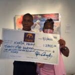 Karim Henry with mother Claretta Randolph with scholarship check